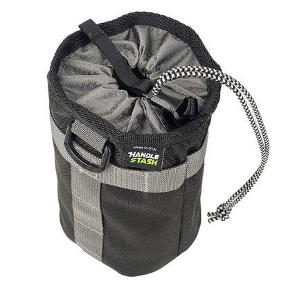 Black stem bag with grey liner cinched closed.